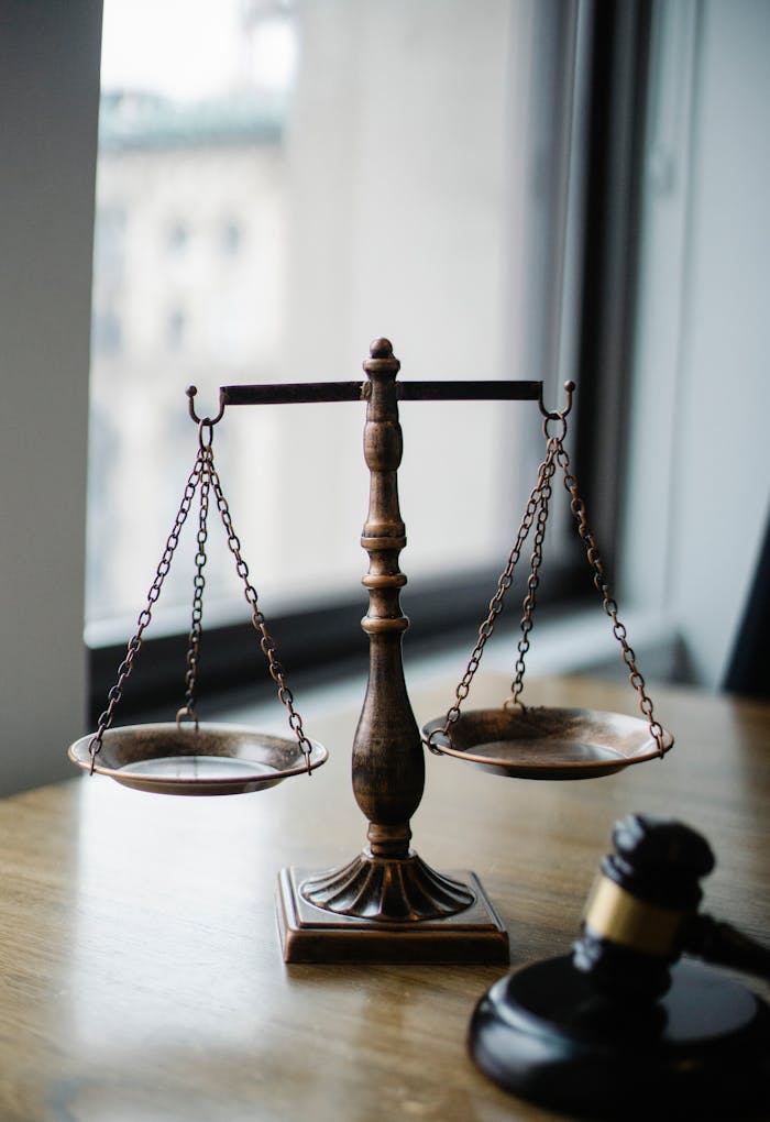 journey Decorative judgement scale and gavel placed on desk in light lawyer office against window