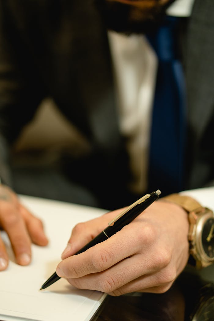 why-choose-us Close-up of hand signing a legal contract with a pen. Ideal for business and legal themes.